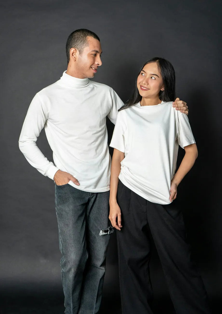 Two friends in white tees standing together and smiling